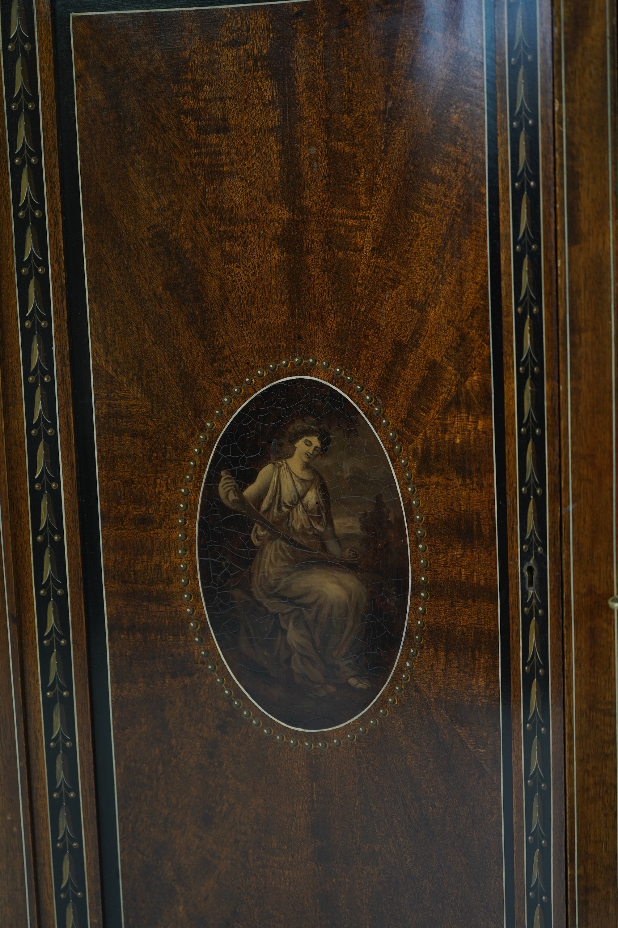 An Edwardian Sheraton Revival painted mahogany bowfront side cabinet